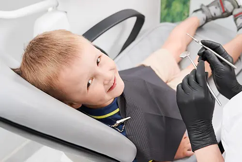 cheerful little boy sitting dental chair dental office 651396 2592 copy